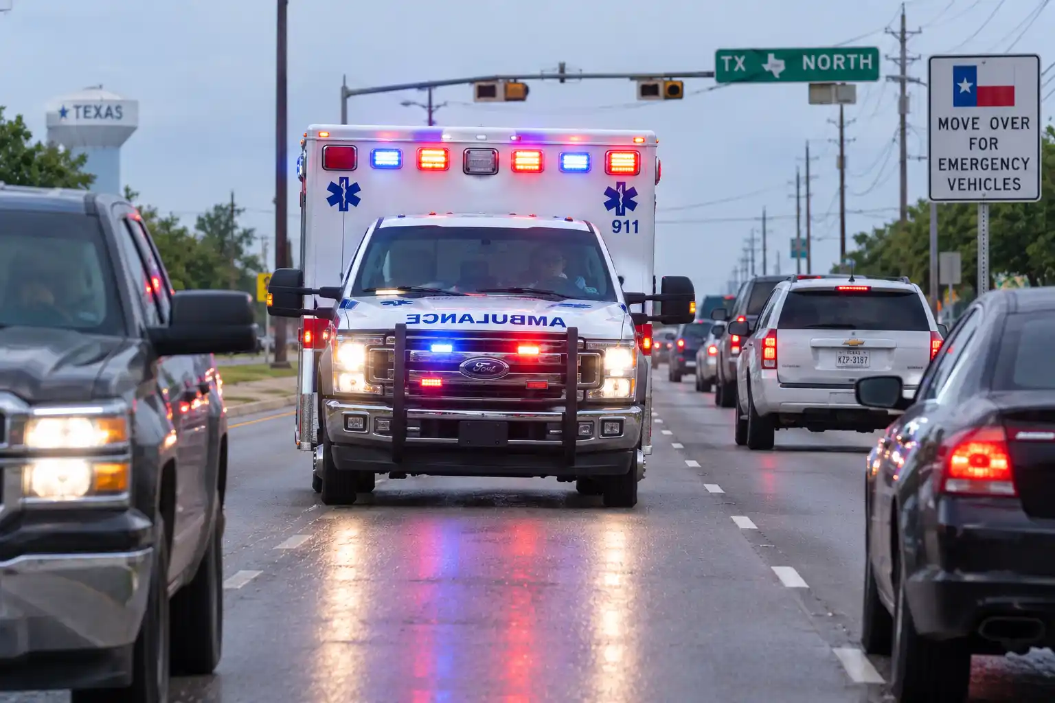 Ambulance with lights and siren approaching traffic in Texas